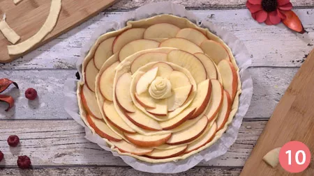 Giunti alla fine, decoriamo il centro della torta con una rosellina di pasta sfoglia